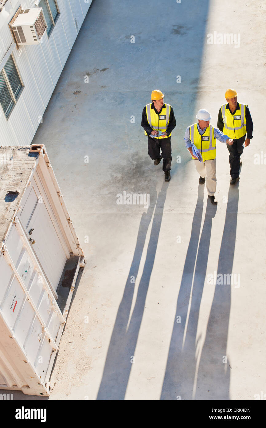 Workers casting shadows on site Stock Photo - Alamy