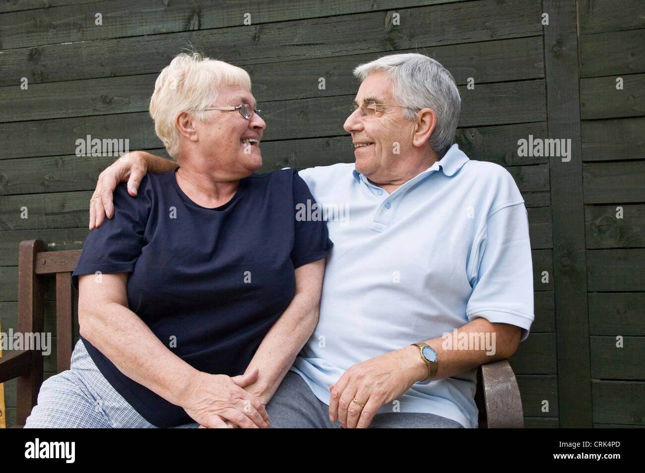 Elderly couple on a bench in their garden Stock Photo Alamy