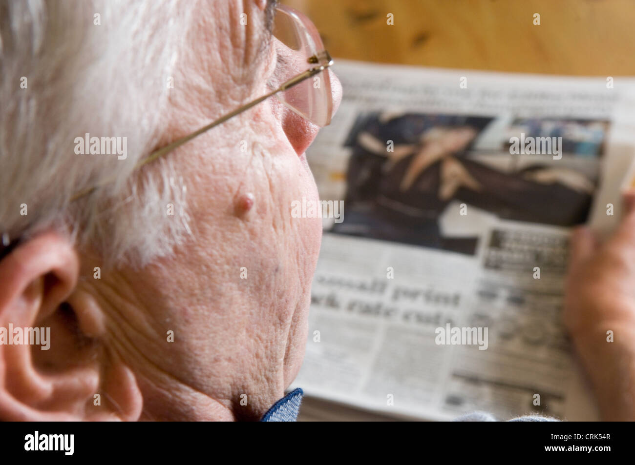 Elderly man reading a newspaper Stock Photo