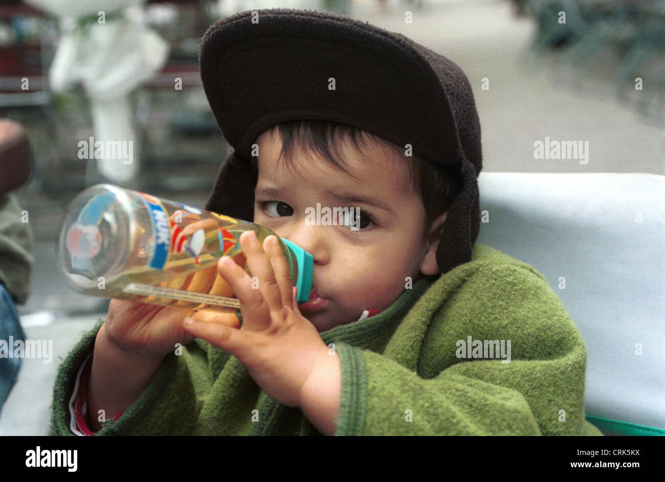 Small child drinking from baby bottle Stock Photo