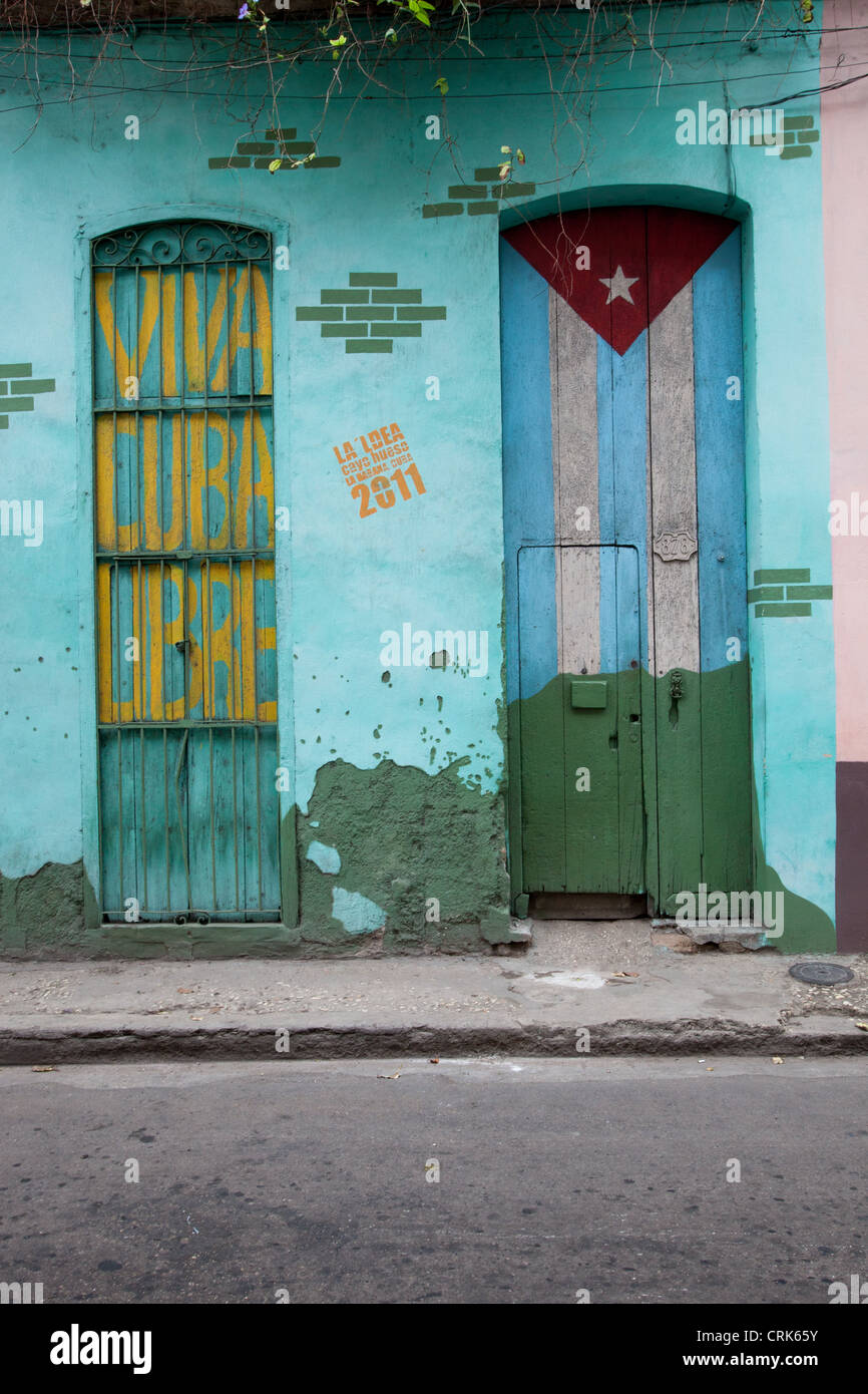 Two doors with signs, a Cuban flag and Viva Cuba Libre, painted on them in Old Havana, Cuba. Stock Photo