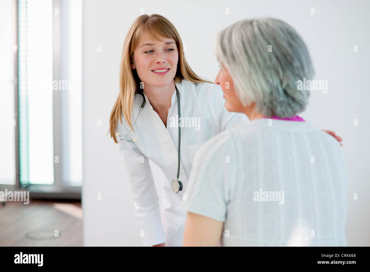 Doctor talking to woman in office Stock Photo