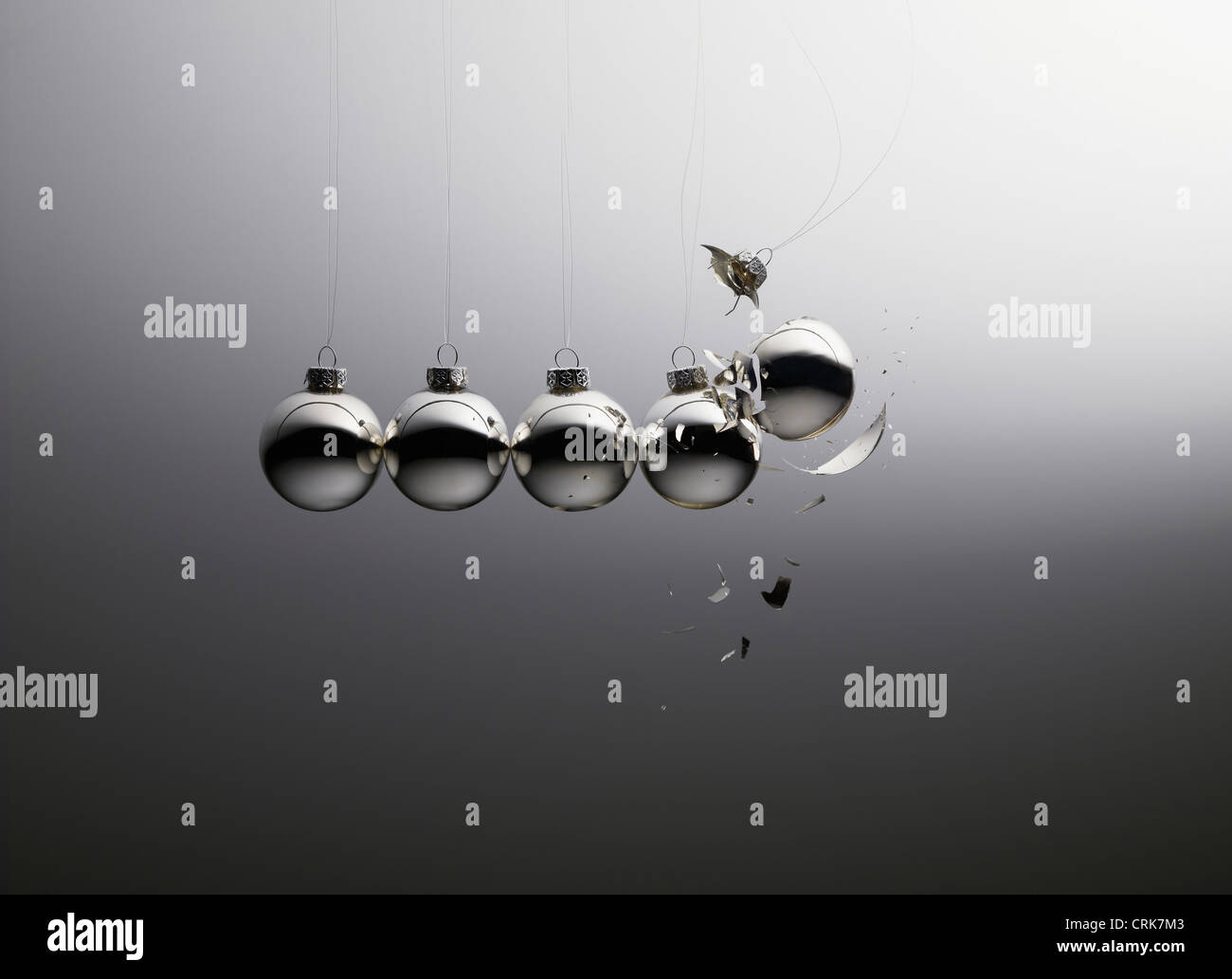 String of Christmas ornaments shattering Stock Photo