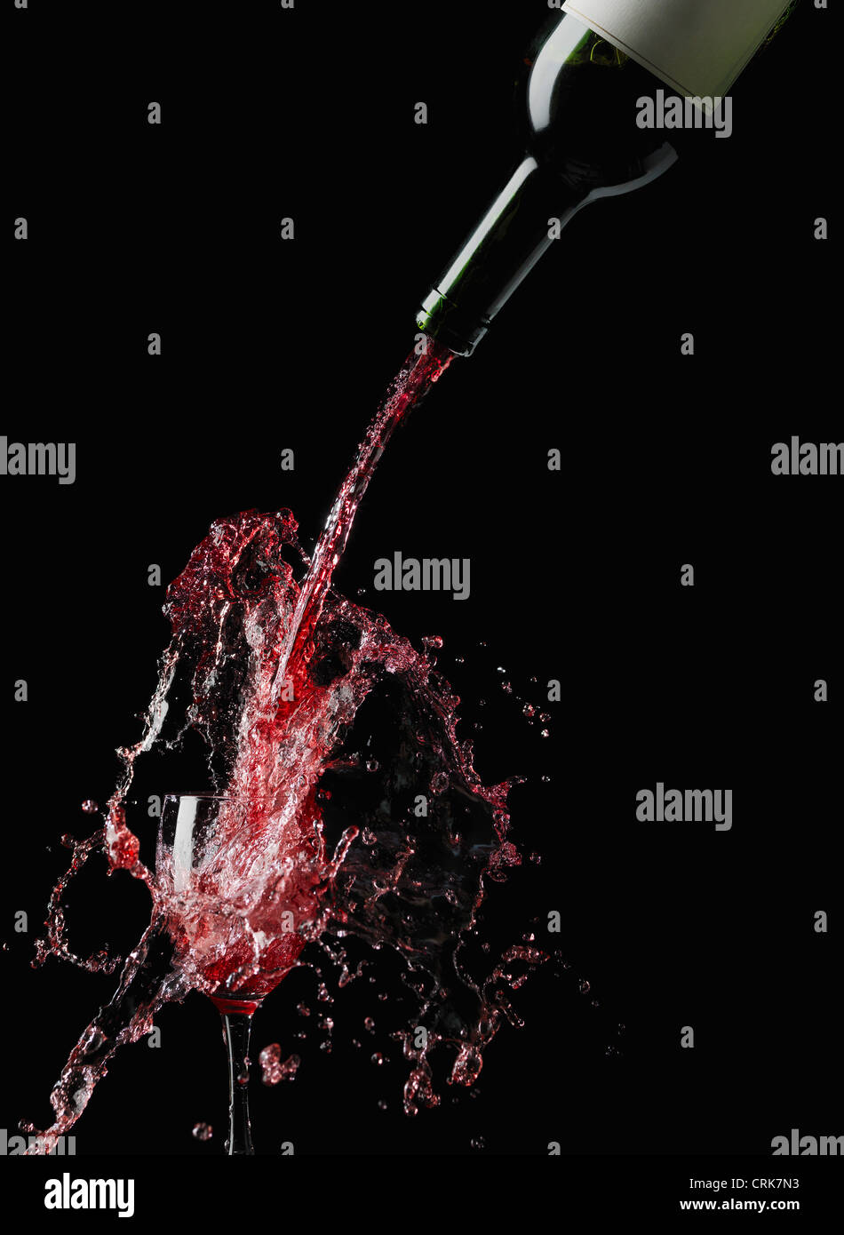 Wine splashing into glass Stock Photo