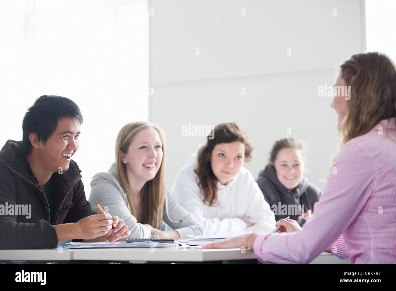 Teacher talking to students in class Stock Photo