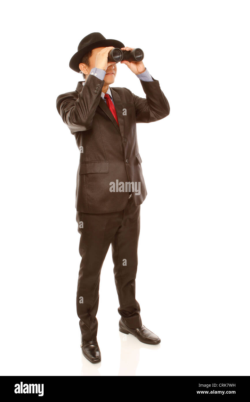 A man in business attire and hat using binoculars (on white) Stock Photo