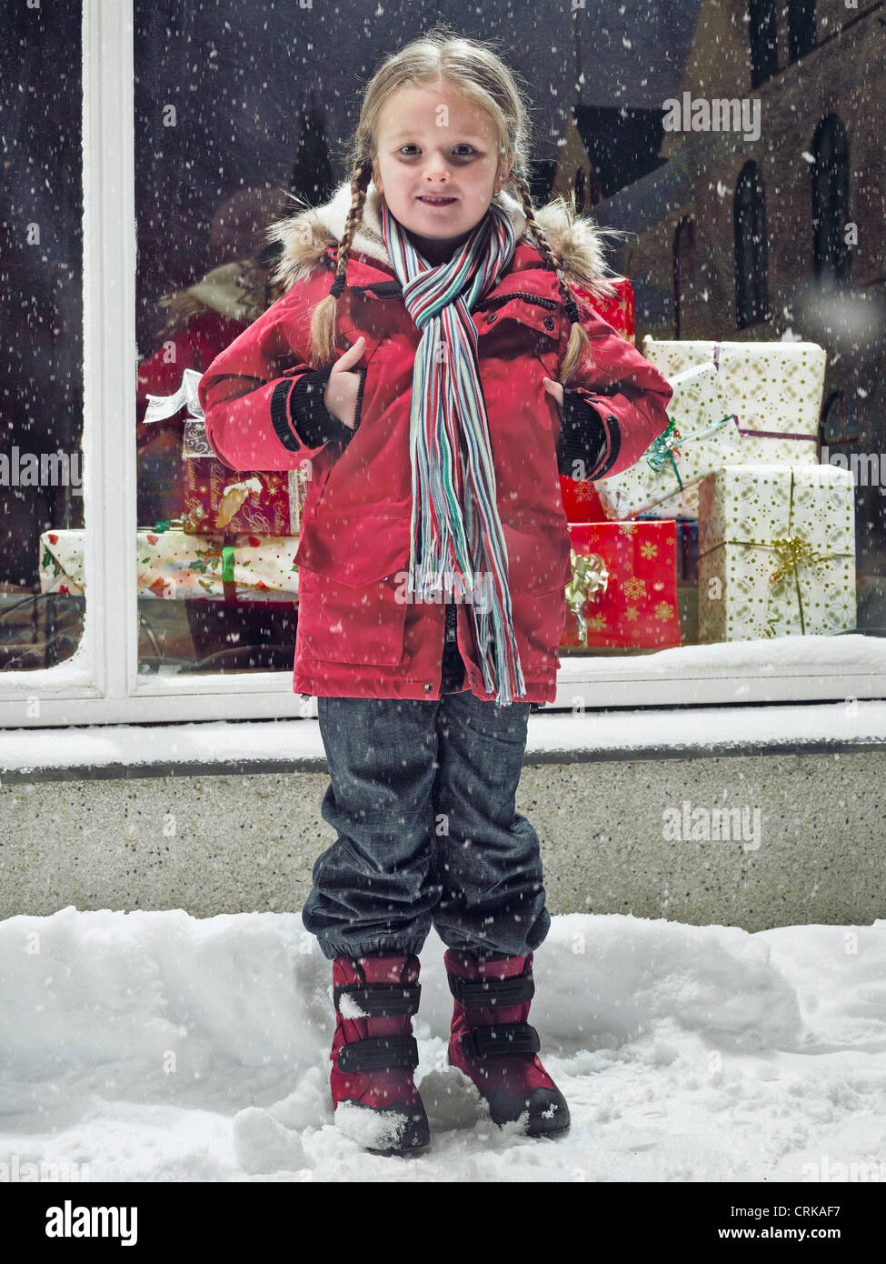 Smiling girl standing in snow Stock Photo - Alamy