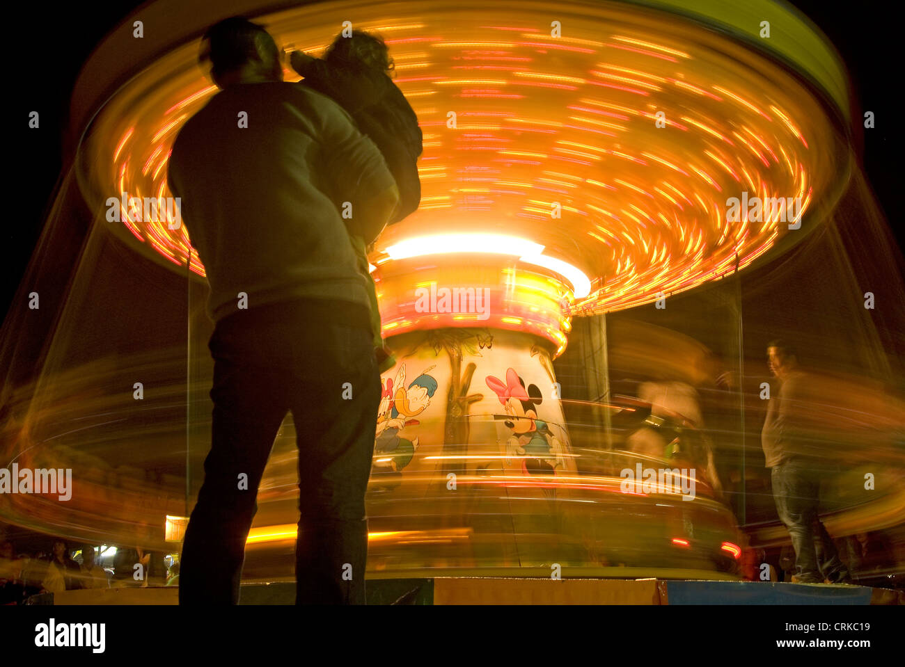 People looking at a Merry-go-round Stock Photo