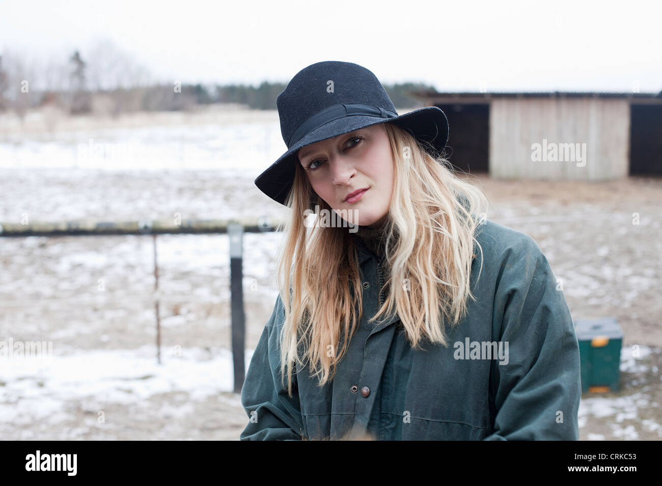 Woman walking in snowy yard Stock Photo - Alamy