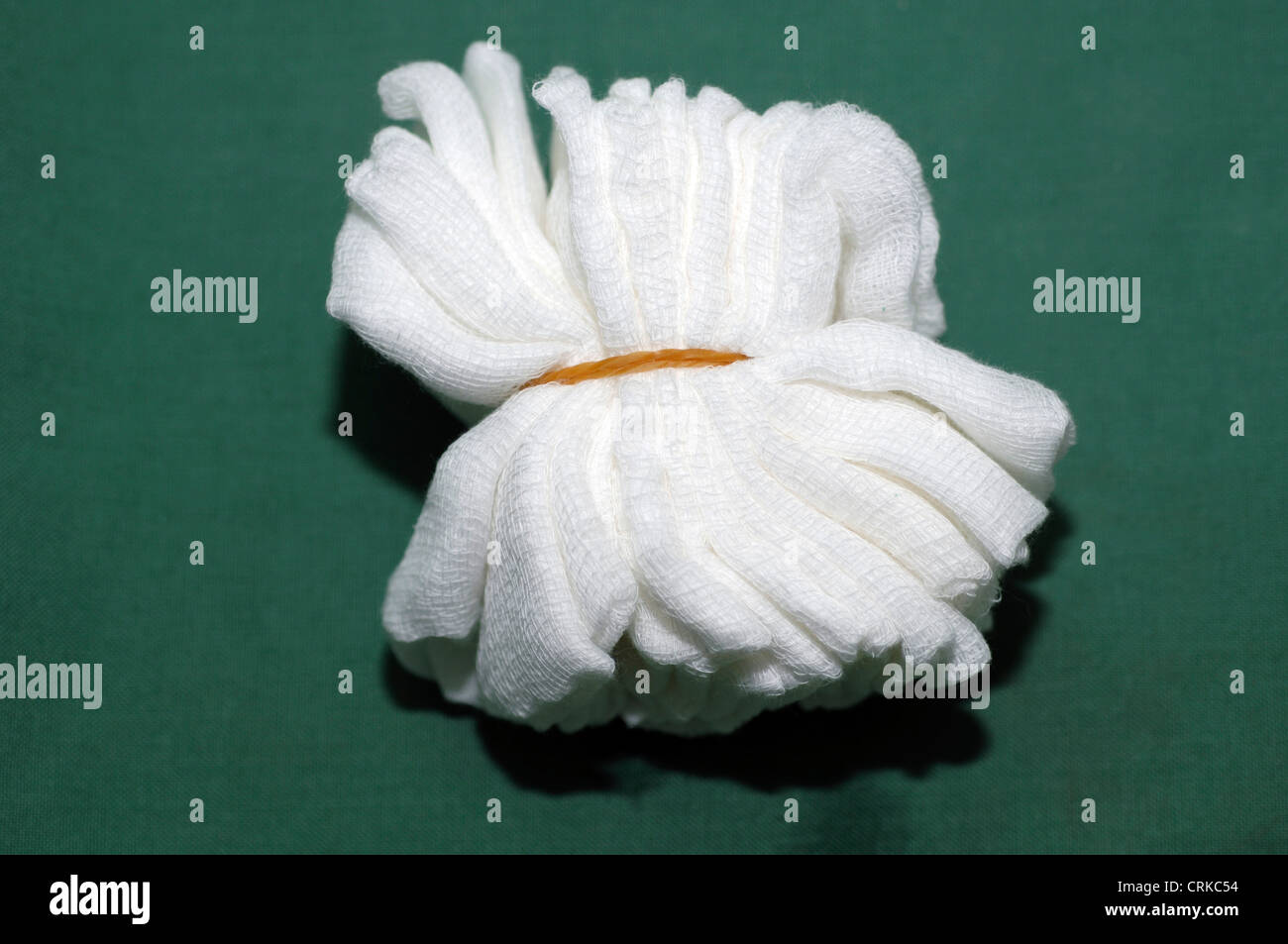 A bundle of white gauze packs that are therapeutically inserted into a body cavity or wound. Stock Photo