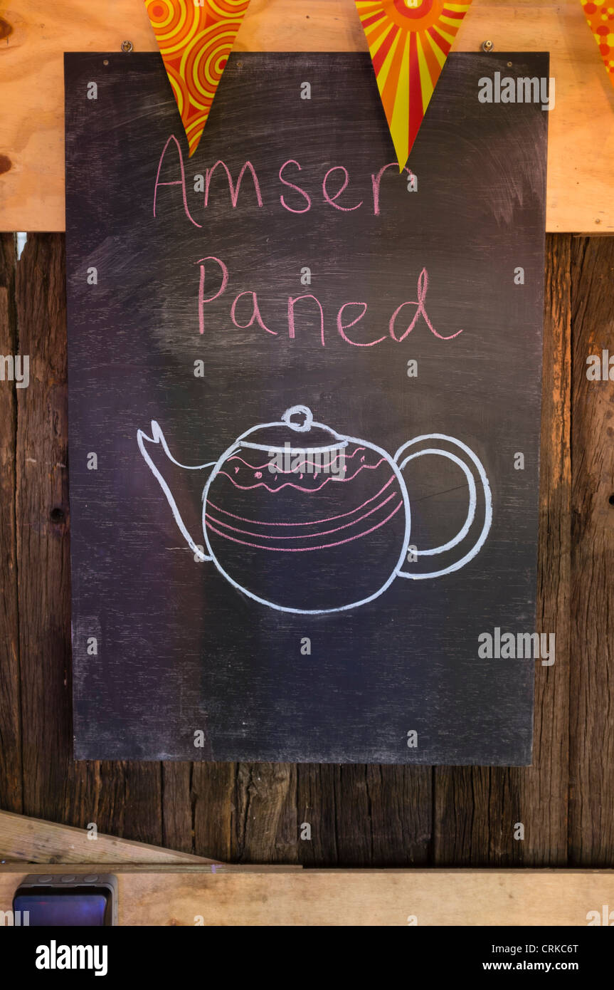 welsh language 'amser paned' [tea time] notice on blackboard at Fforest outdoor adventure centre near Cardigan west Wales UK Stock Photo