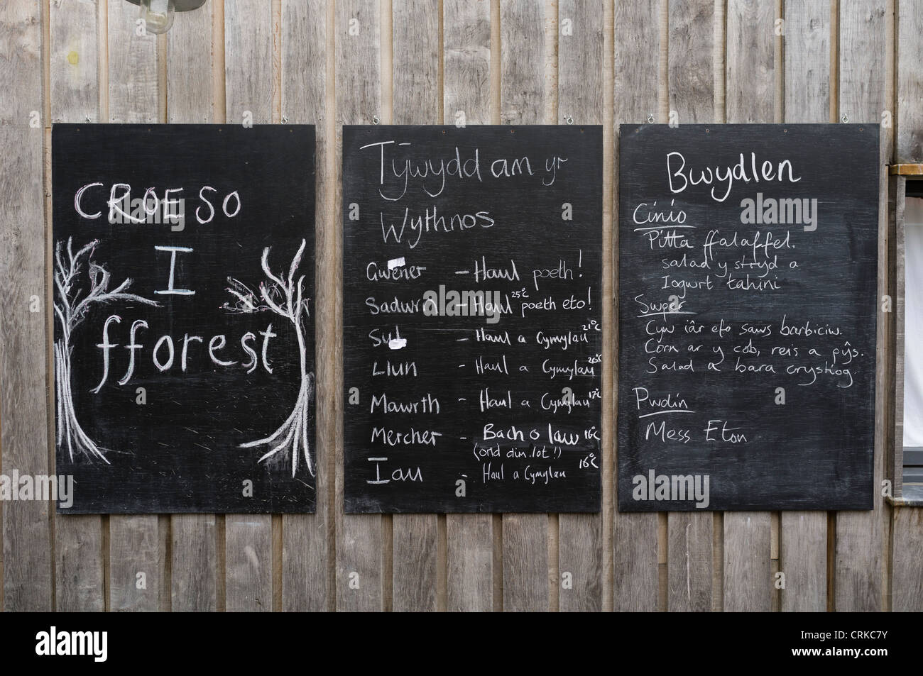 Bilingual welsh english notices on blackboard at Fforest outdoor adventure centre near Cardigan west Wales UK Stock Photo