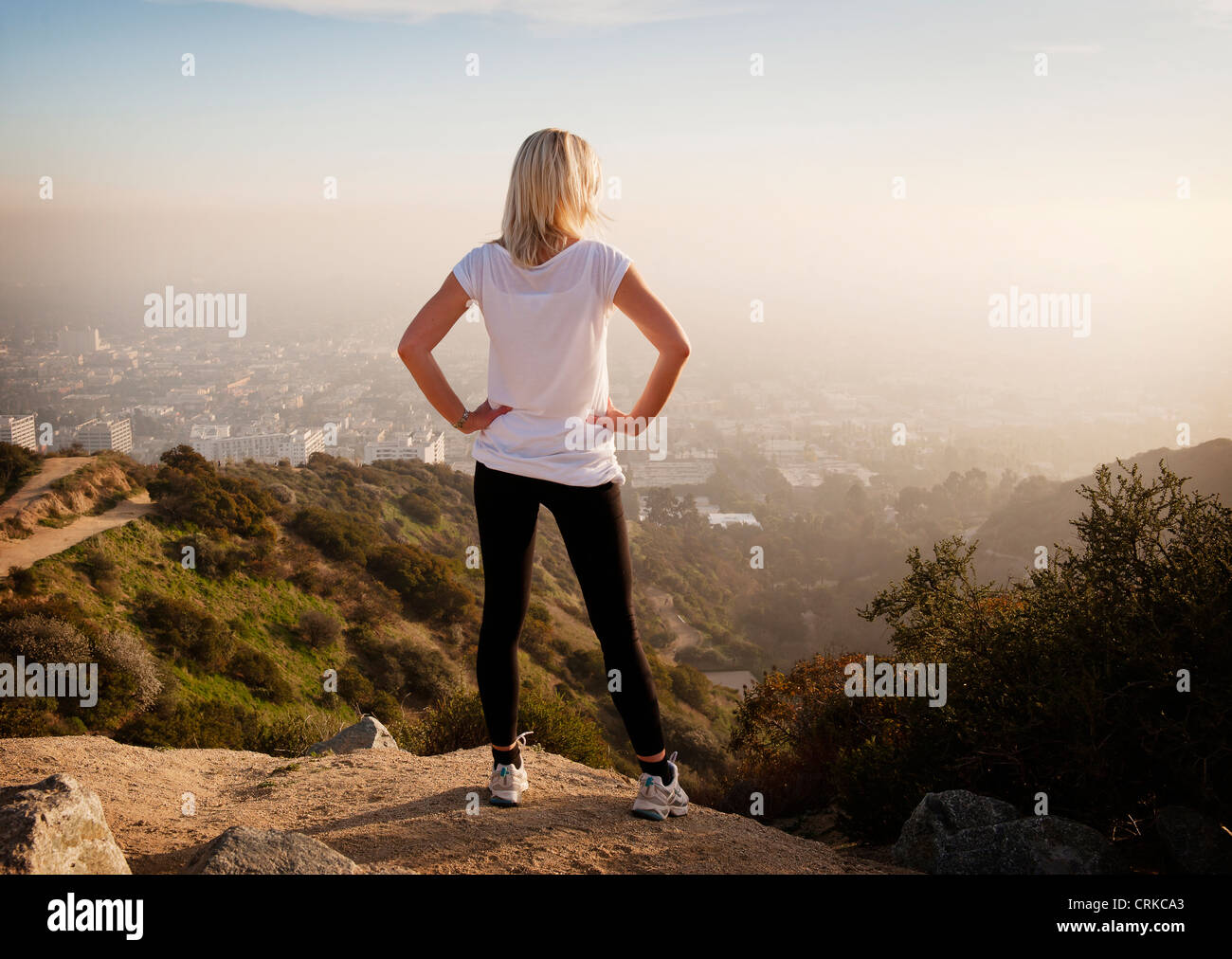 Woman overlooking view from hilltop Stock Photo