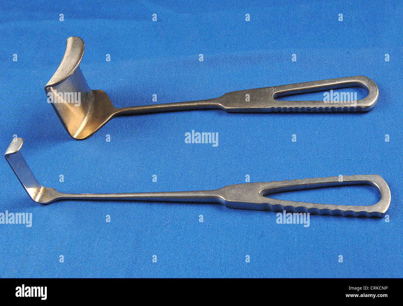 Metal Retractors on a blue background Stock Photo