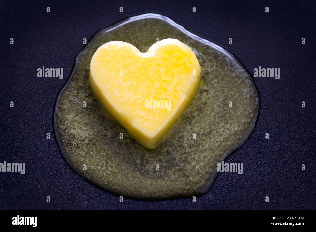 a heart shaped butter pat melting on a nonstick surface healthy diet
