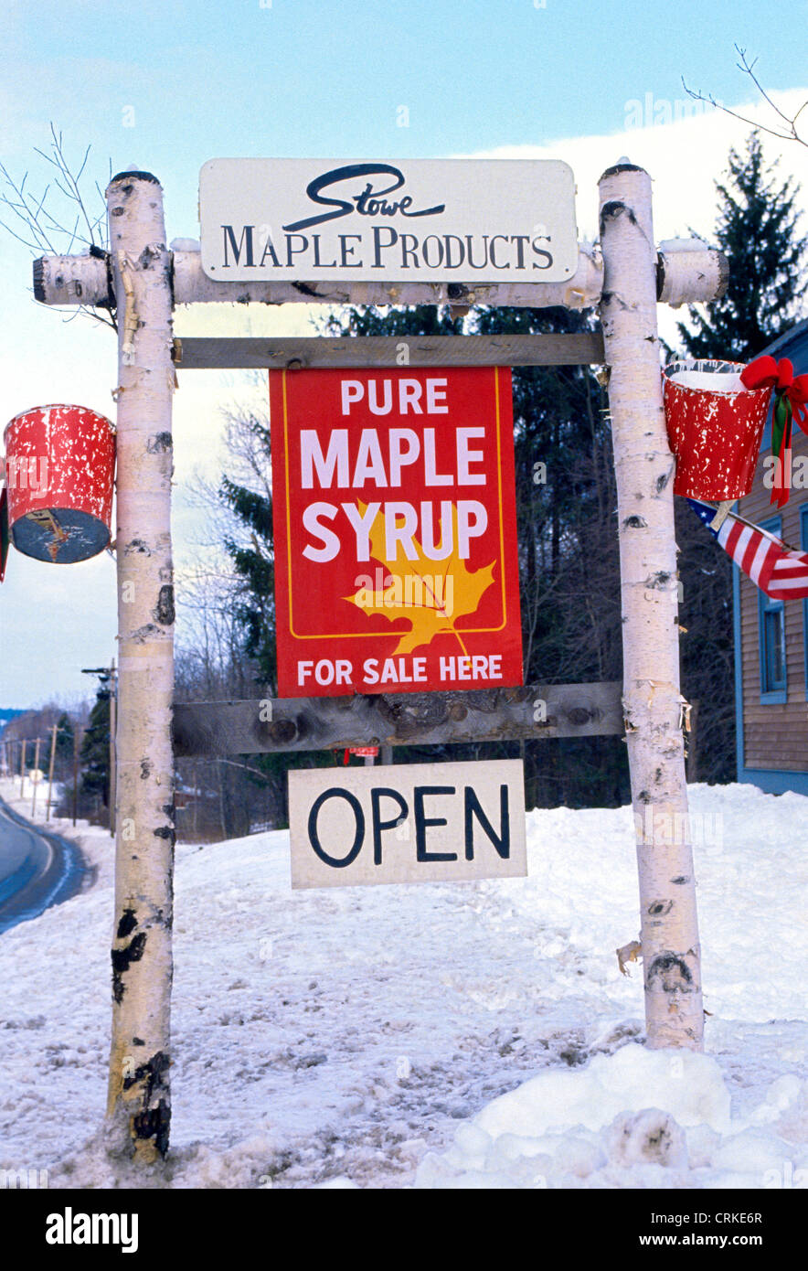 A roadside sign in the snow advertises pure maple syrup for sale at the Stowe Maple Products