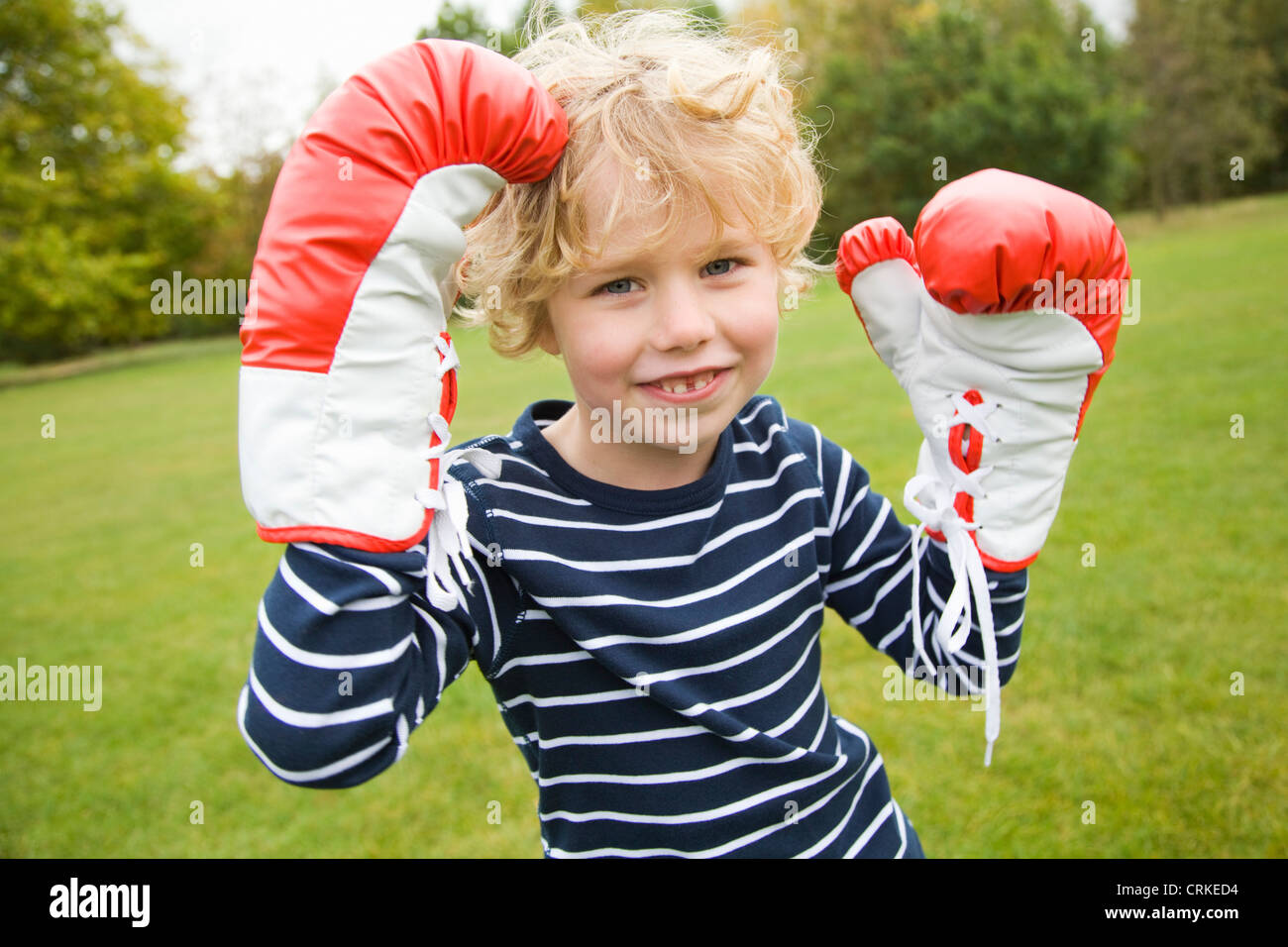 Boy playing with boxing gloves outdoors Stock Photo Alamy