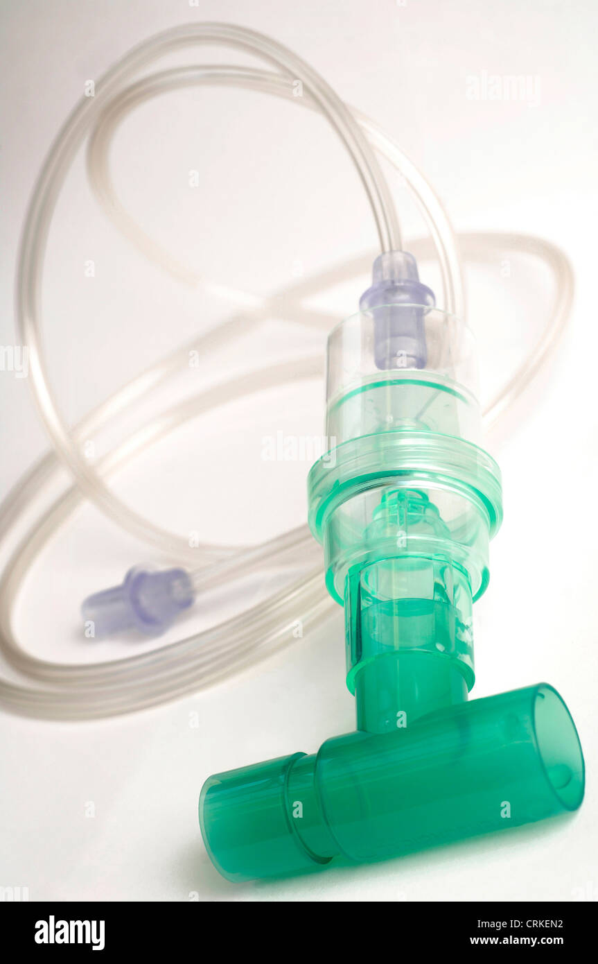 Close up of a connector tube, commonly used to connect facemasks to oxygen cylinders and similar equiment. The green section of the connector tube houses two valves, one which allows air to move up the tube and into the facemask when the patient breathes in. The second valve allows air to move out when the patient exhales. The device can act as an indicator Stock Photo
