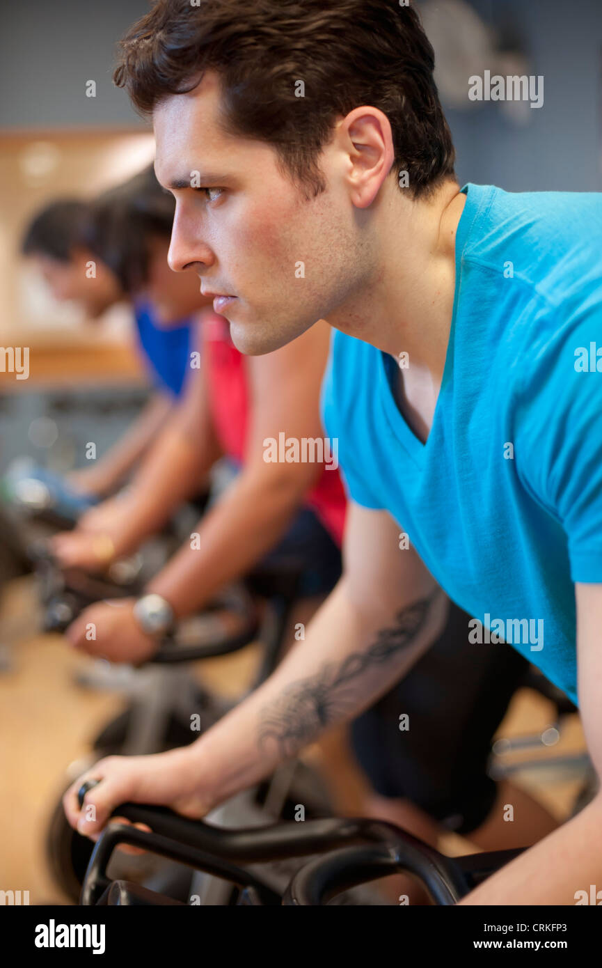 People using spin machines in gym Stock Photo Alamy