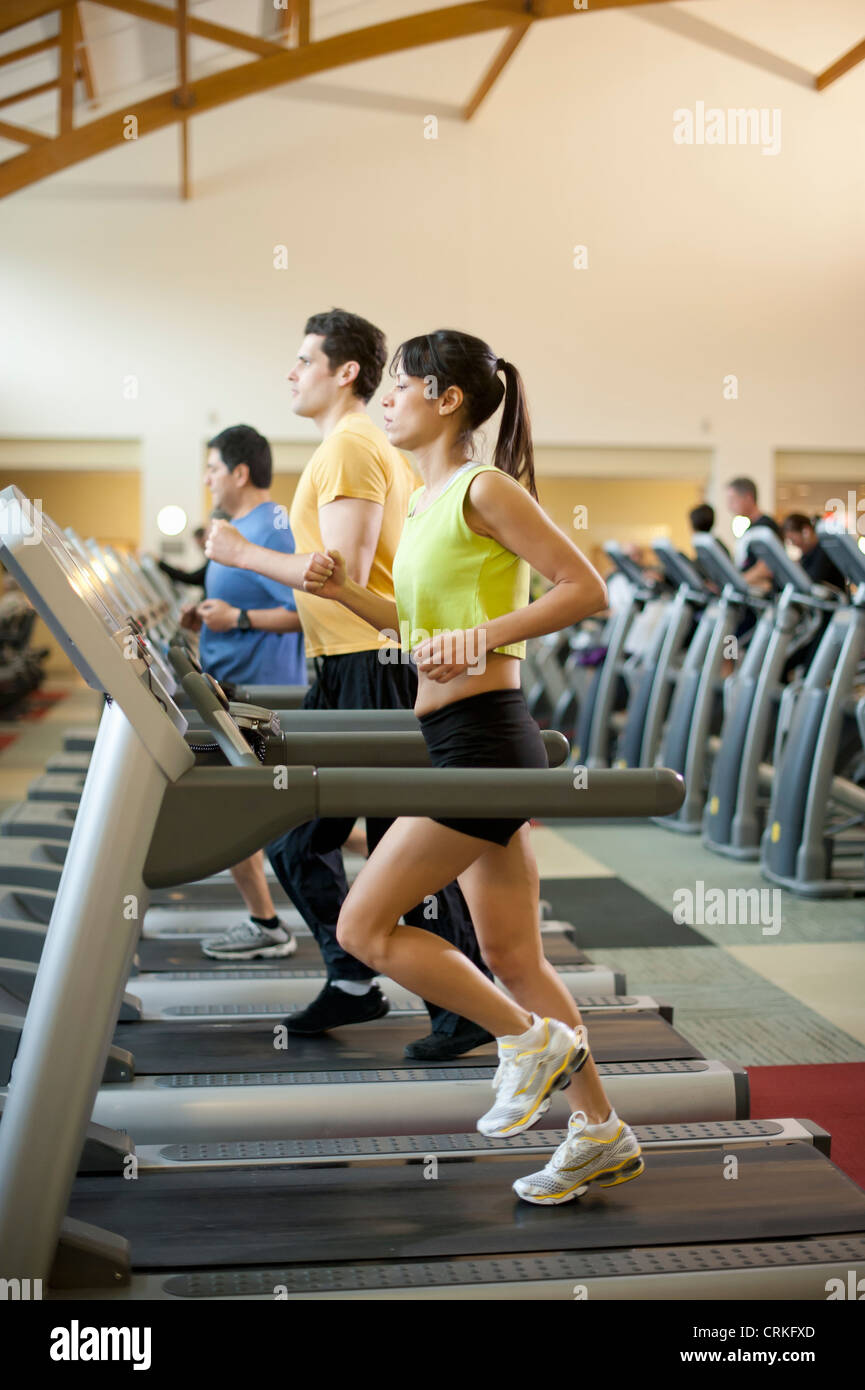 People using treadmills in gym Stock Photo