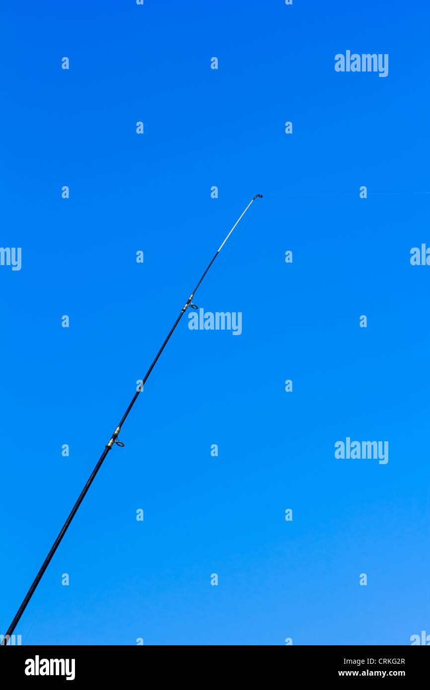 Fishing rod with sea and sky as background Stock Photo
