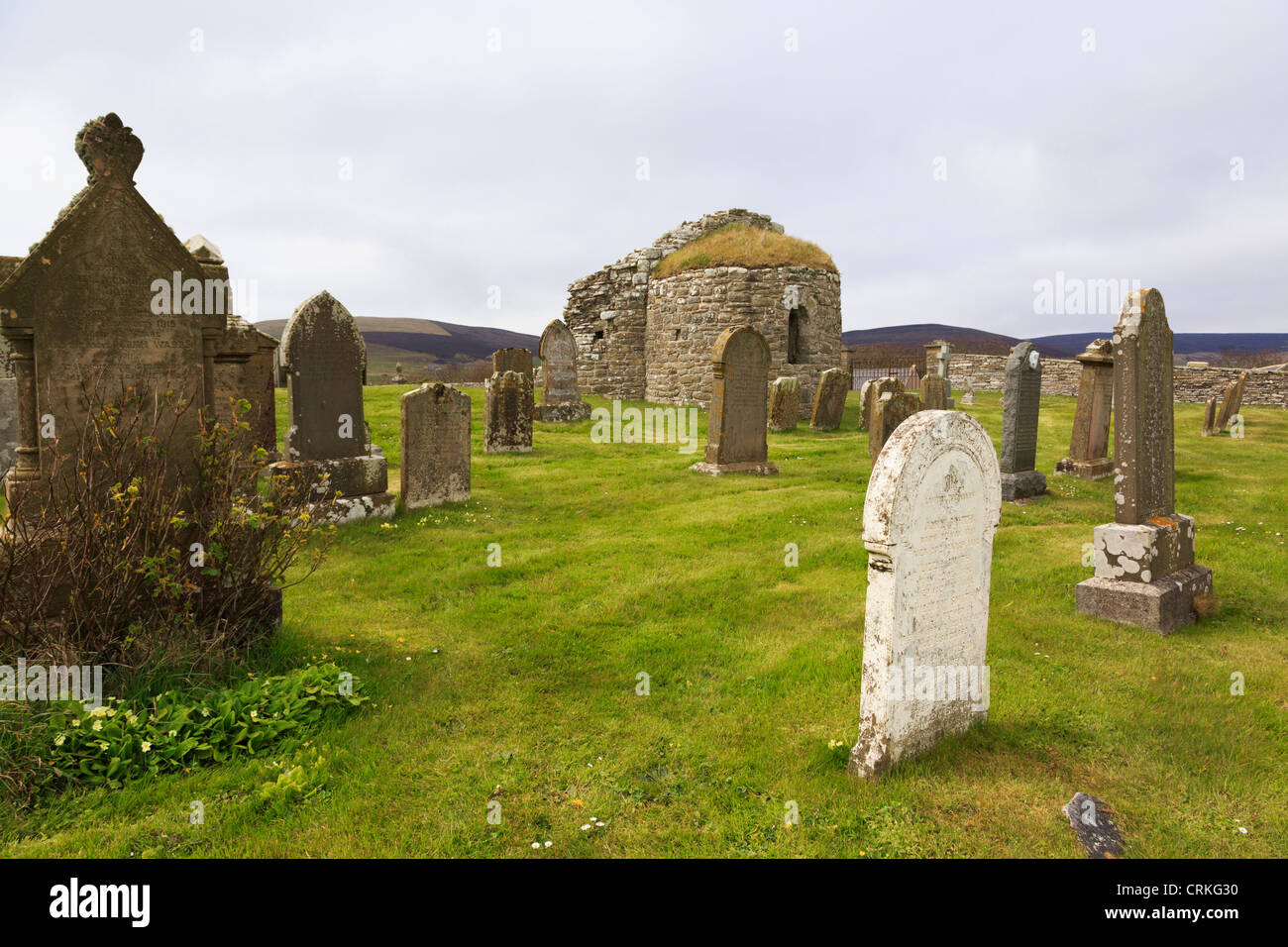 Ruins of 12th century Round Kirk (church of St Nicholas) with old gravestones in churchyard at Orphir Orkney Islands Scotland UK Stock Photo