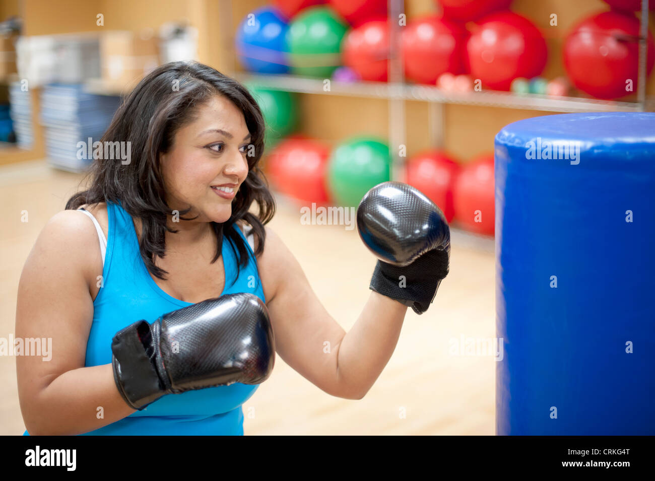 Woman punching bag in gym Stock Photo Alamy