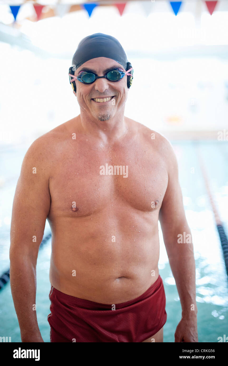 Man wearing swim gear at pool Stock Photo