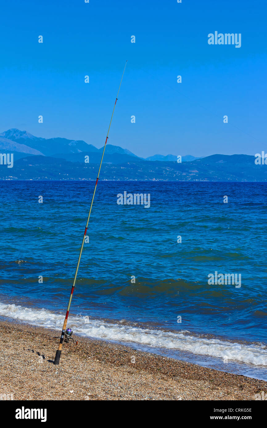 Fishing rod with sea and sky as background Stock Photo
