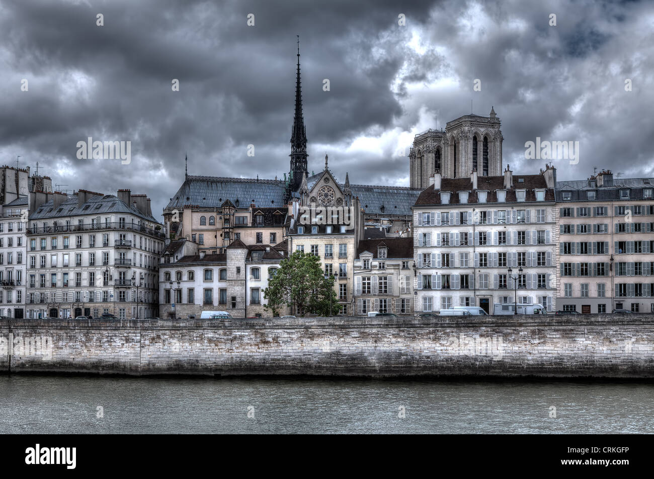 Traditional parisian building along Seine river and Notre Dame de Paris Cathedral on background in Paris, France Stock Photo