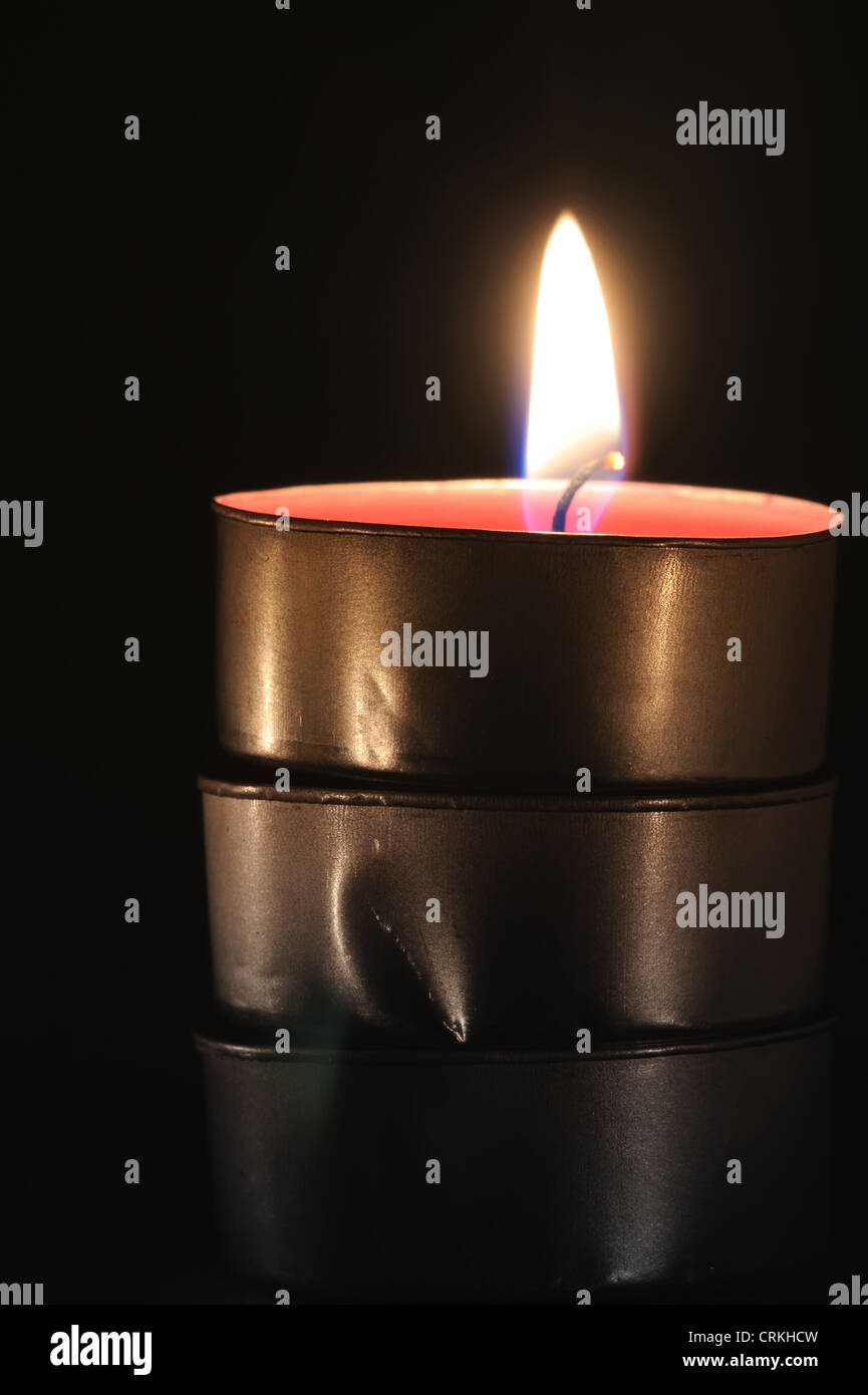 Burning candle on a black background Stock Photo - Alamy