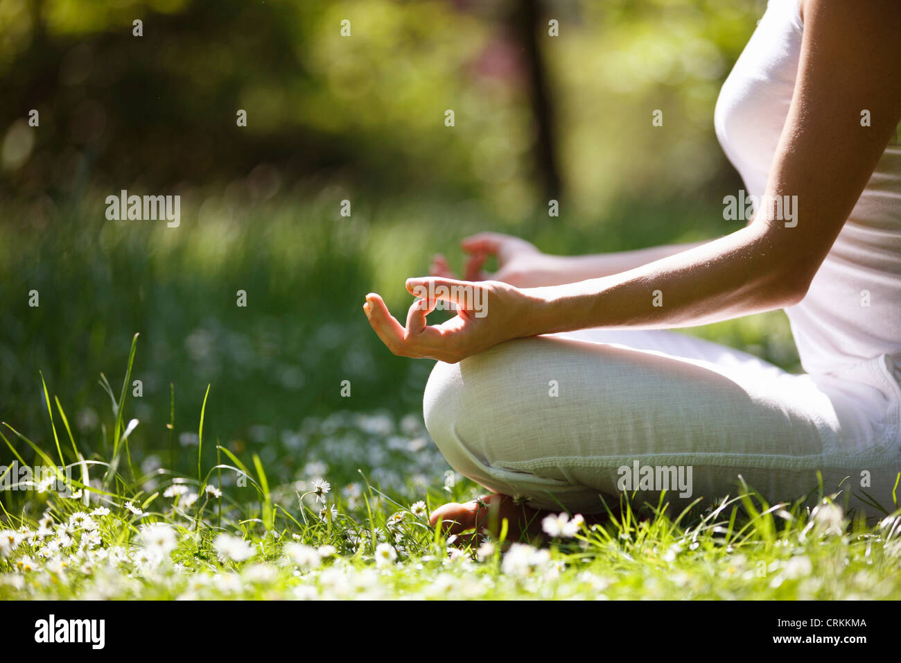 A young woman meditating outside, close up of hands Stock Photo - Alamy