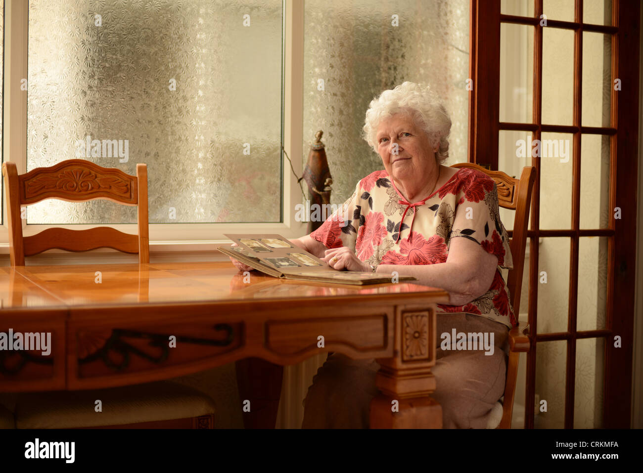 Elderly lady and photographs hi-res stock photography and images - Alamy