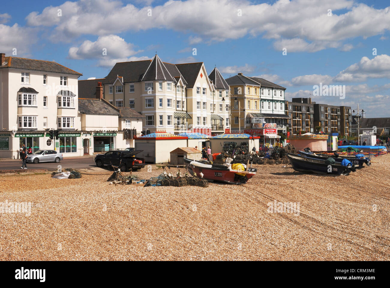 Shingle Beach and seafront at Bognor Regis in West Sussex. England. With fishing boats drawn up out of water. Stock Photo