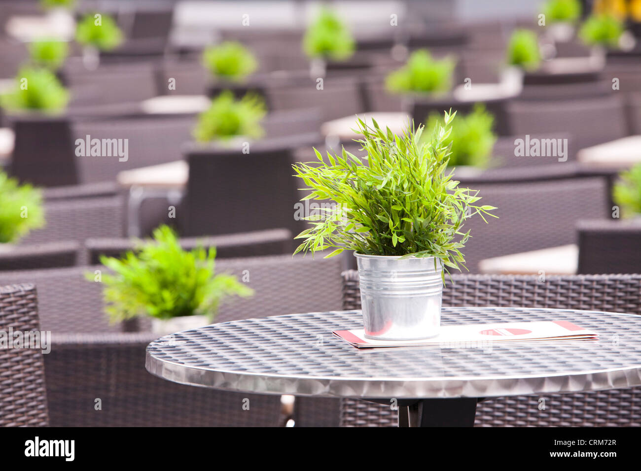 Tables of an outdoor restaurant in the City behind the Swiss Re Tower, London, UK. Stock Photo