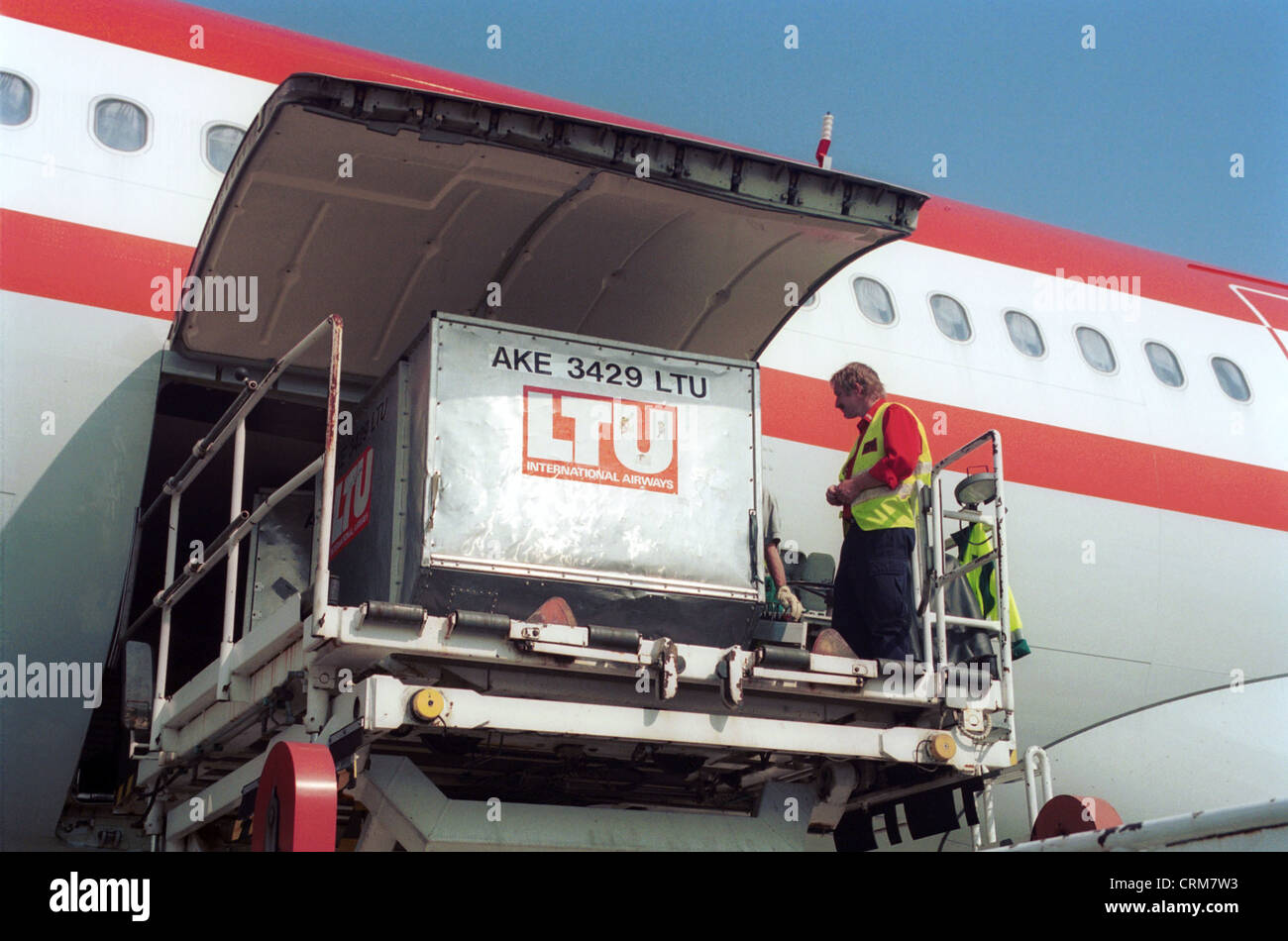 Container is loaded from aircraft Stock Photo