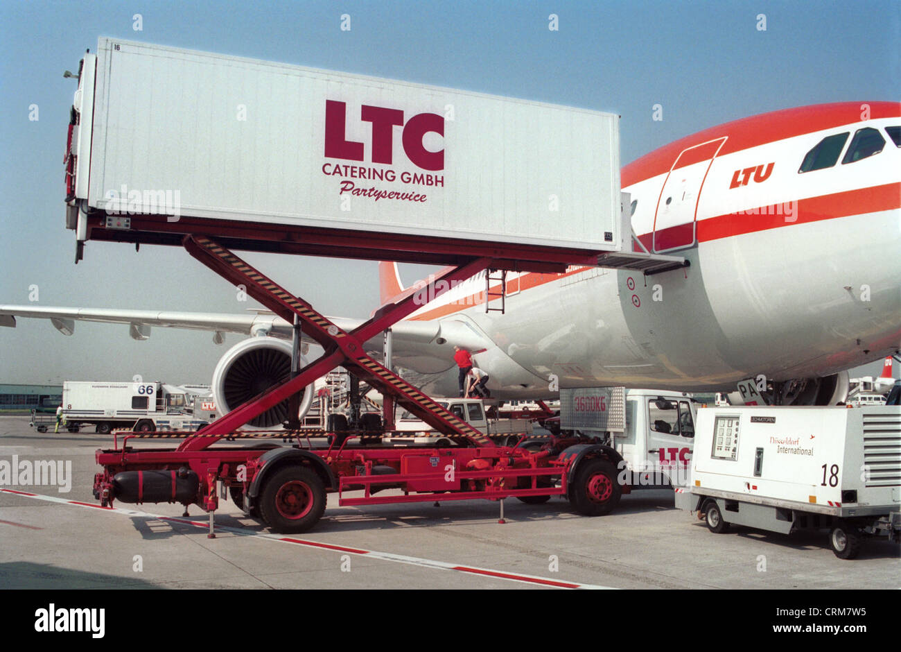 Aircraft is loaded from catering trolley Stock Photo