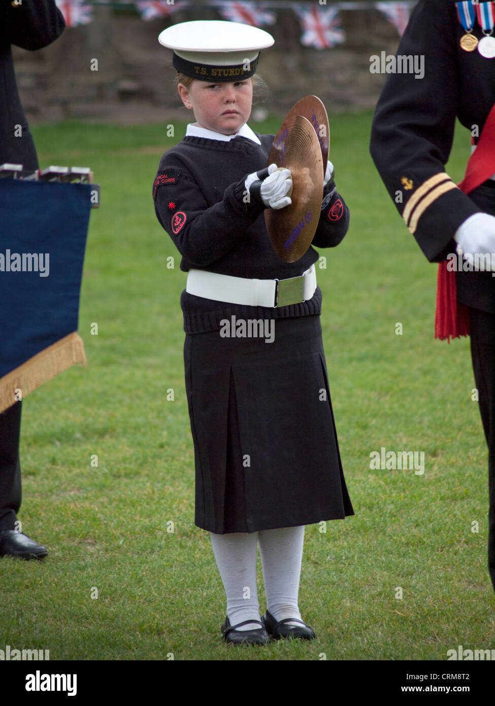 A young Sea Cadet plays the cymbals. Stock Photo