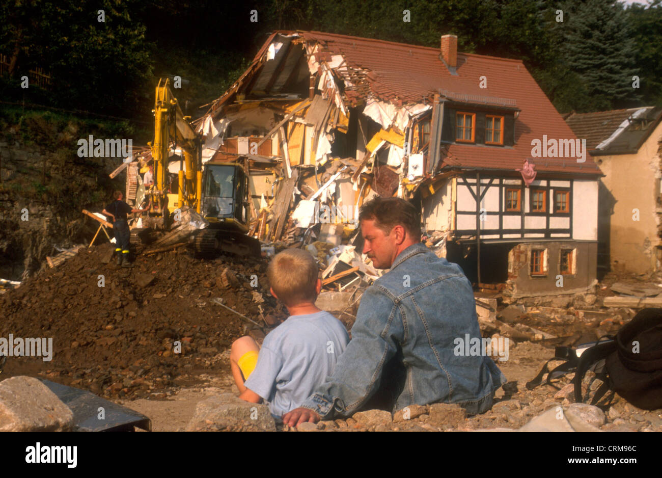 Father and son look to demolition of her house after the flood in Saxony Stock Photo