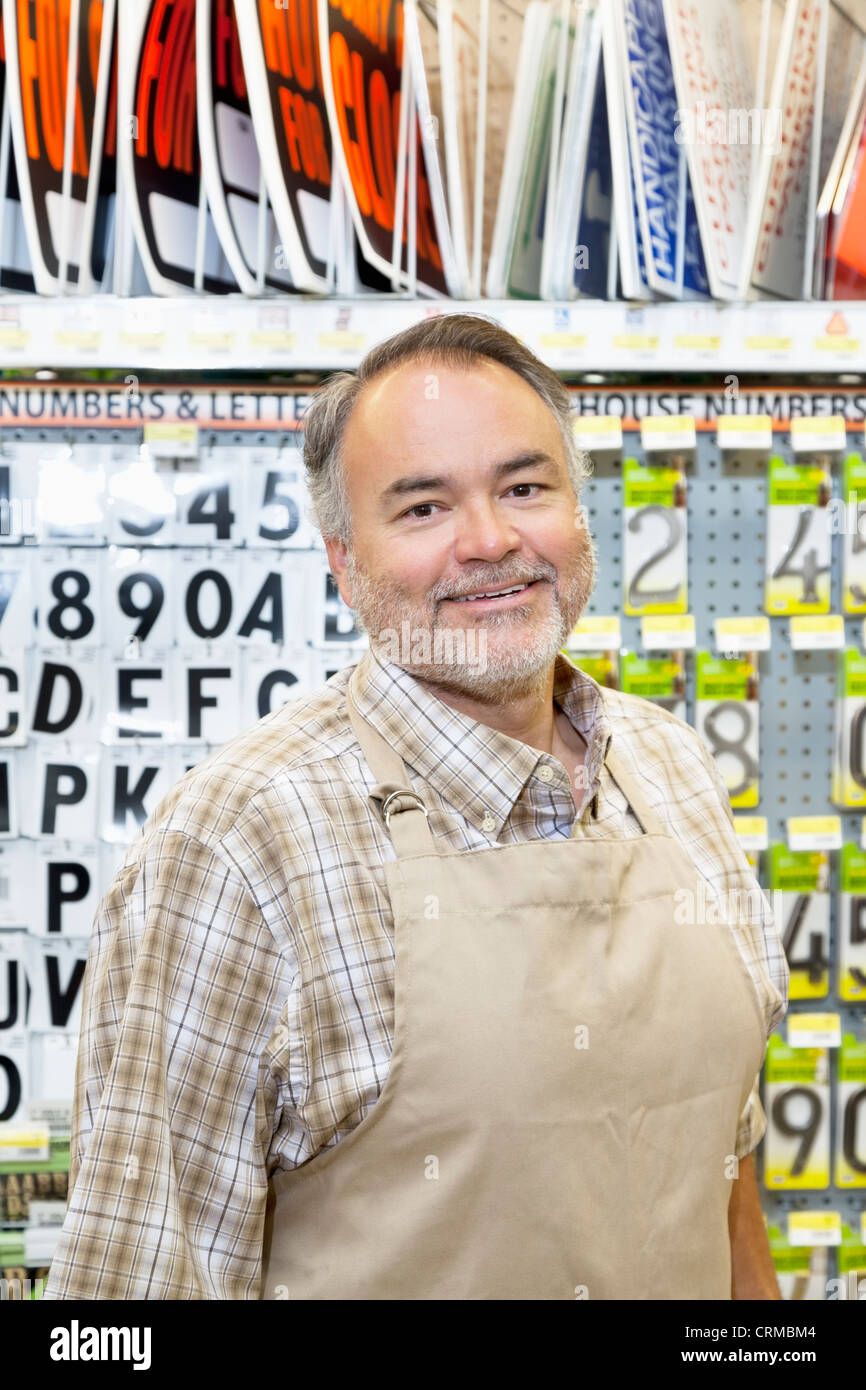 Portrait of a happy mature salesperson in hardware store Stock Photo