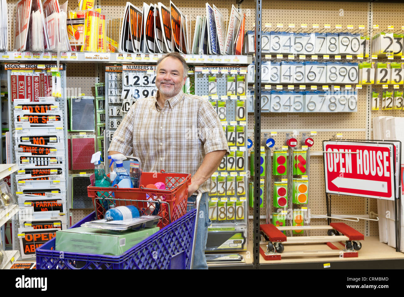 Portrait of a mature man with shopping cart in hardware store Stock Photo