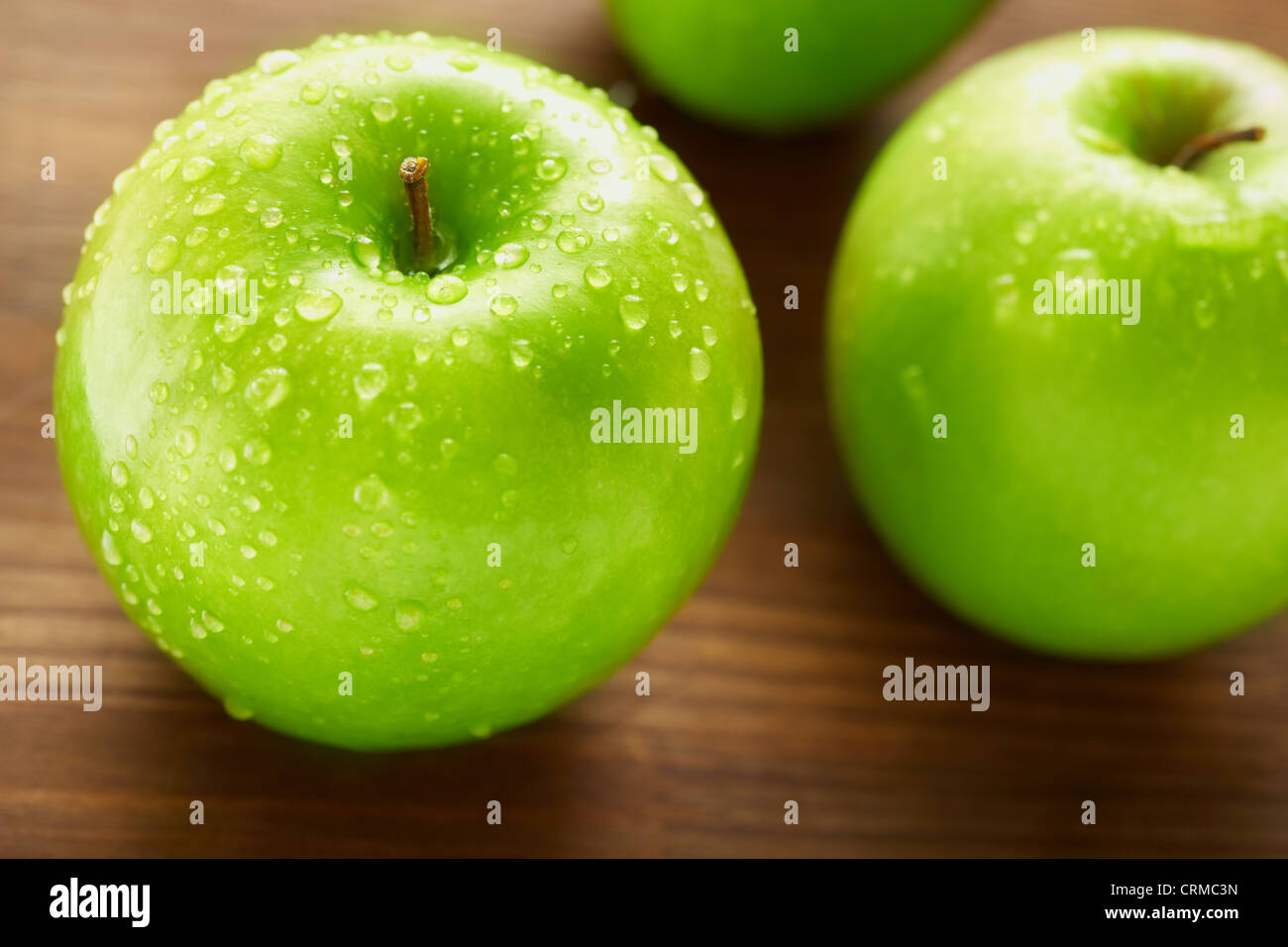 Healthy nutrition concept with apples on the wooden table, selective focus Stock Photo