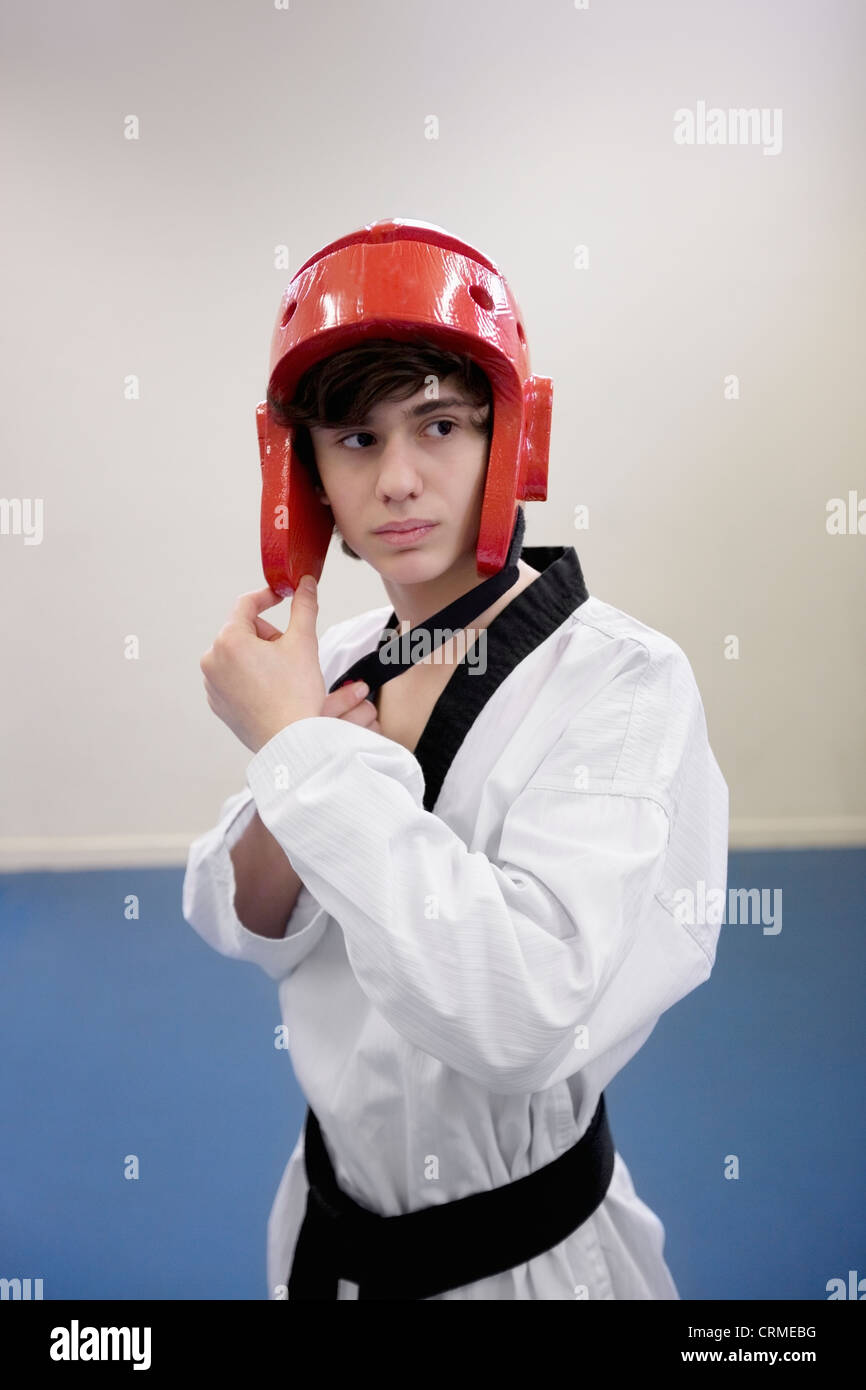 Teenage boy wearing martial arts headgear while looking away Stock