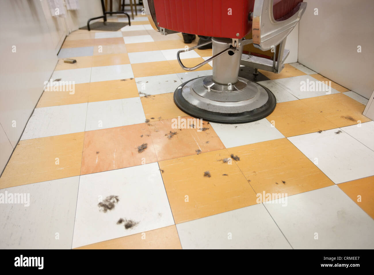 An empty barber shop with cut hair on floor Stock Photo