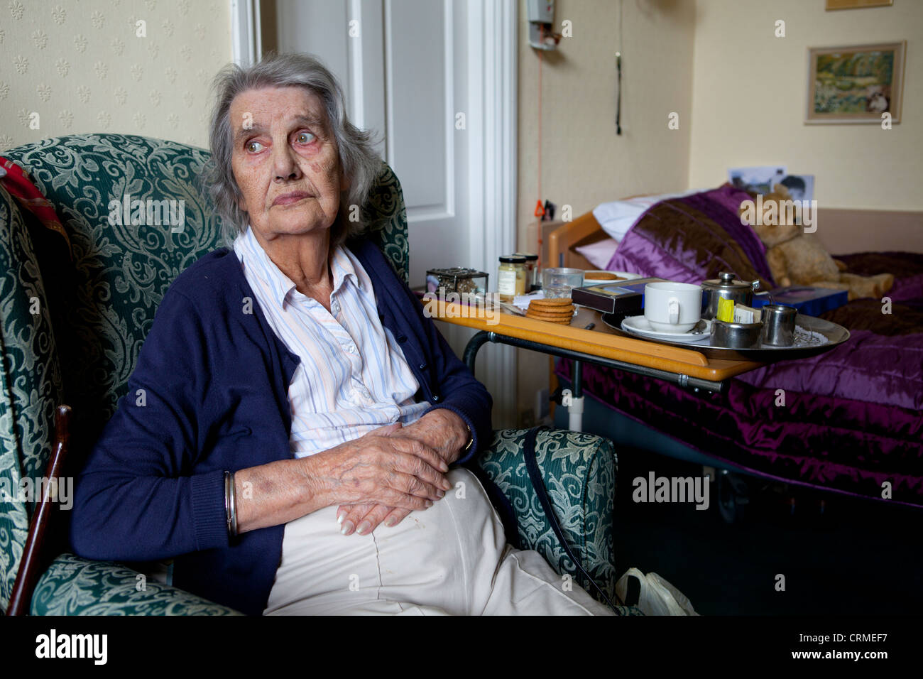 Sad elderly woman in a care home. Stock Photo