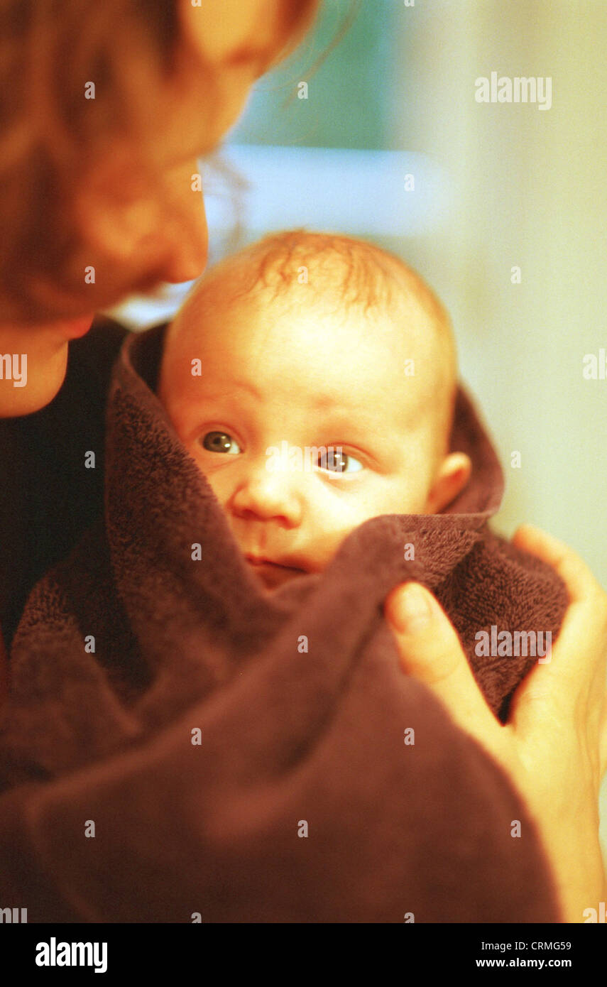 Baby in towel after bath Stock Photo Alamy