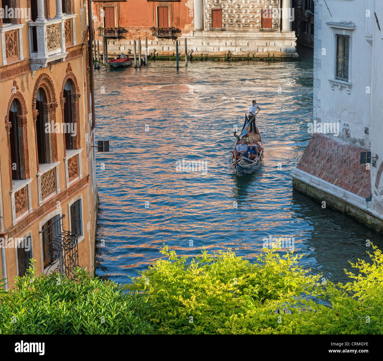 Gondola on the Grand Canal turning into a side canal in Dorsoduro Venice Stock Photo