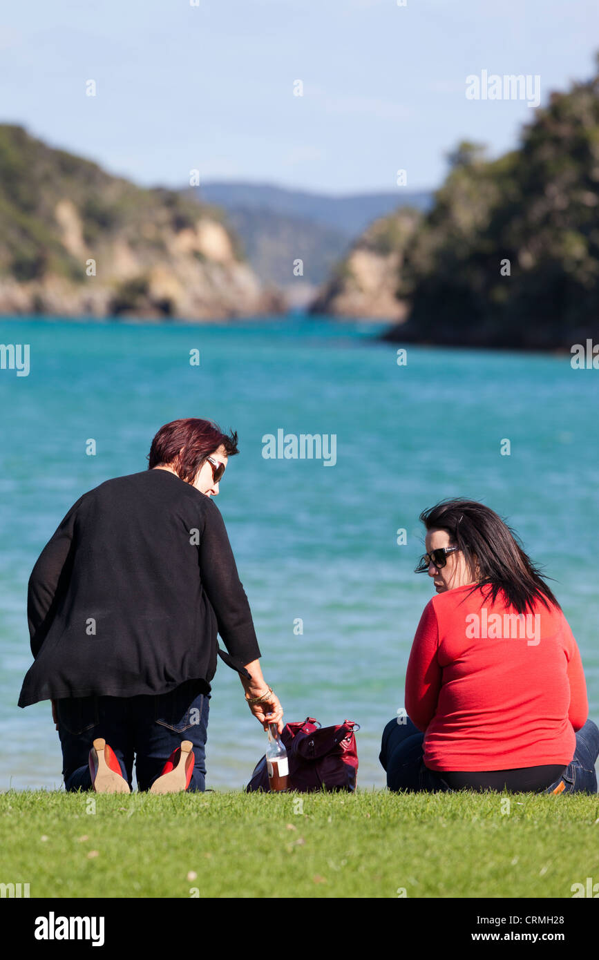 Two ladies on the shore 11 - Bay of Islands, New Zealand Stock Photo