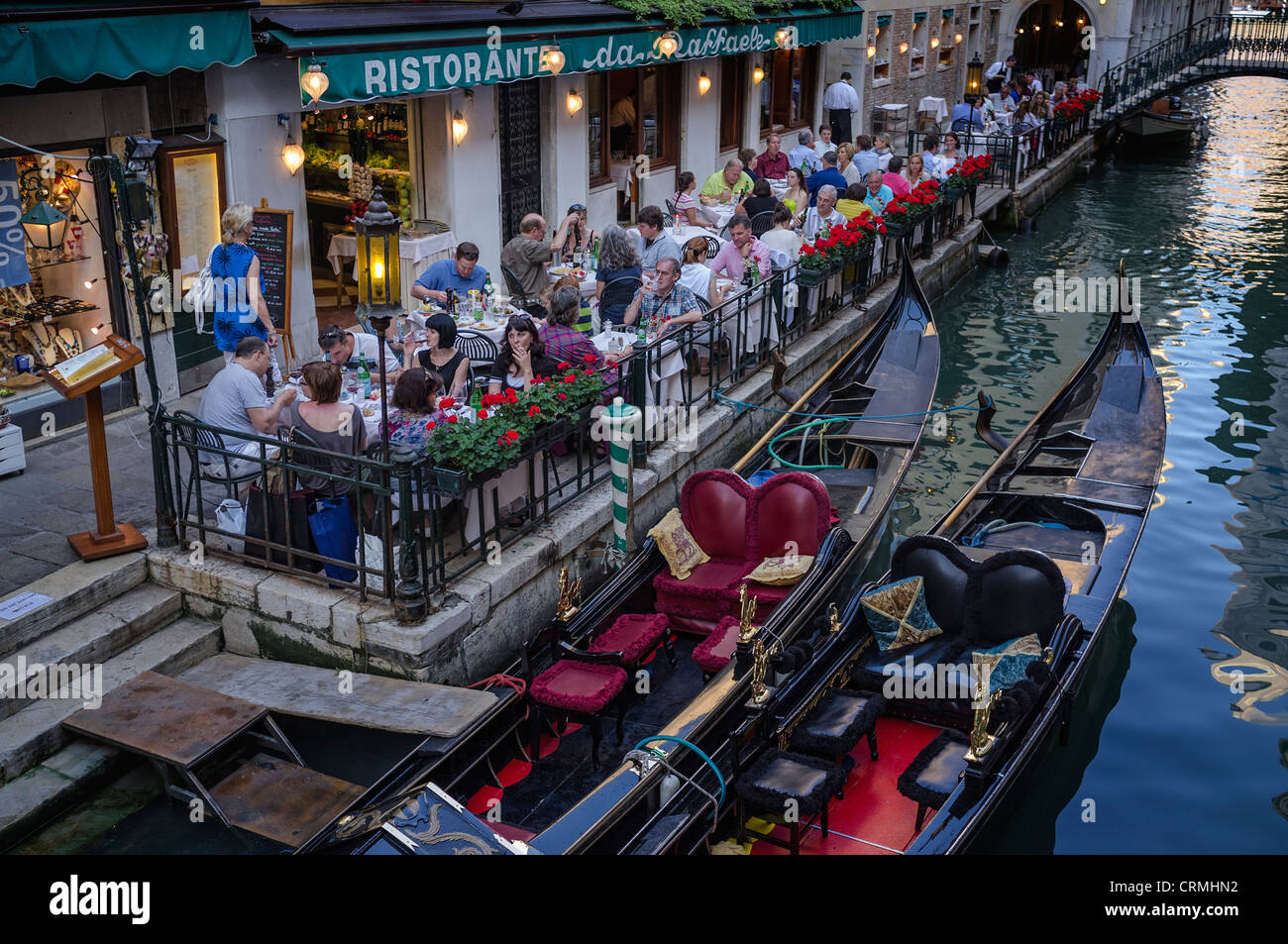 Gondolas moored alongside the Ristorante Da Raffaele in Venice Stock Photo