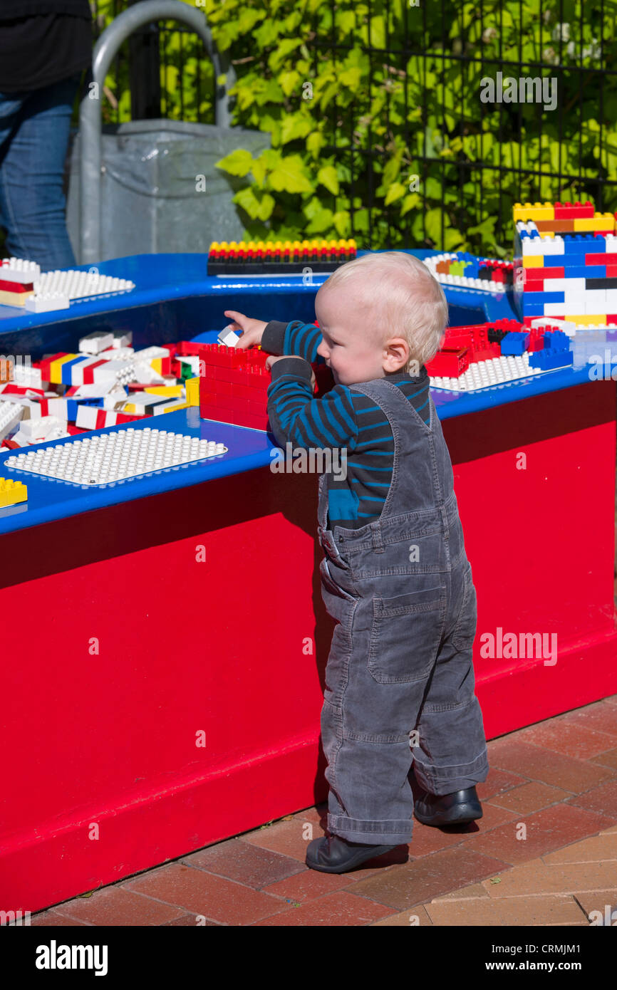 Small boy in dungarees playing with Lego, Legoland, Billund, Denmark Stock  Photo - Alamy
